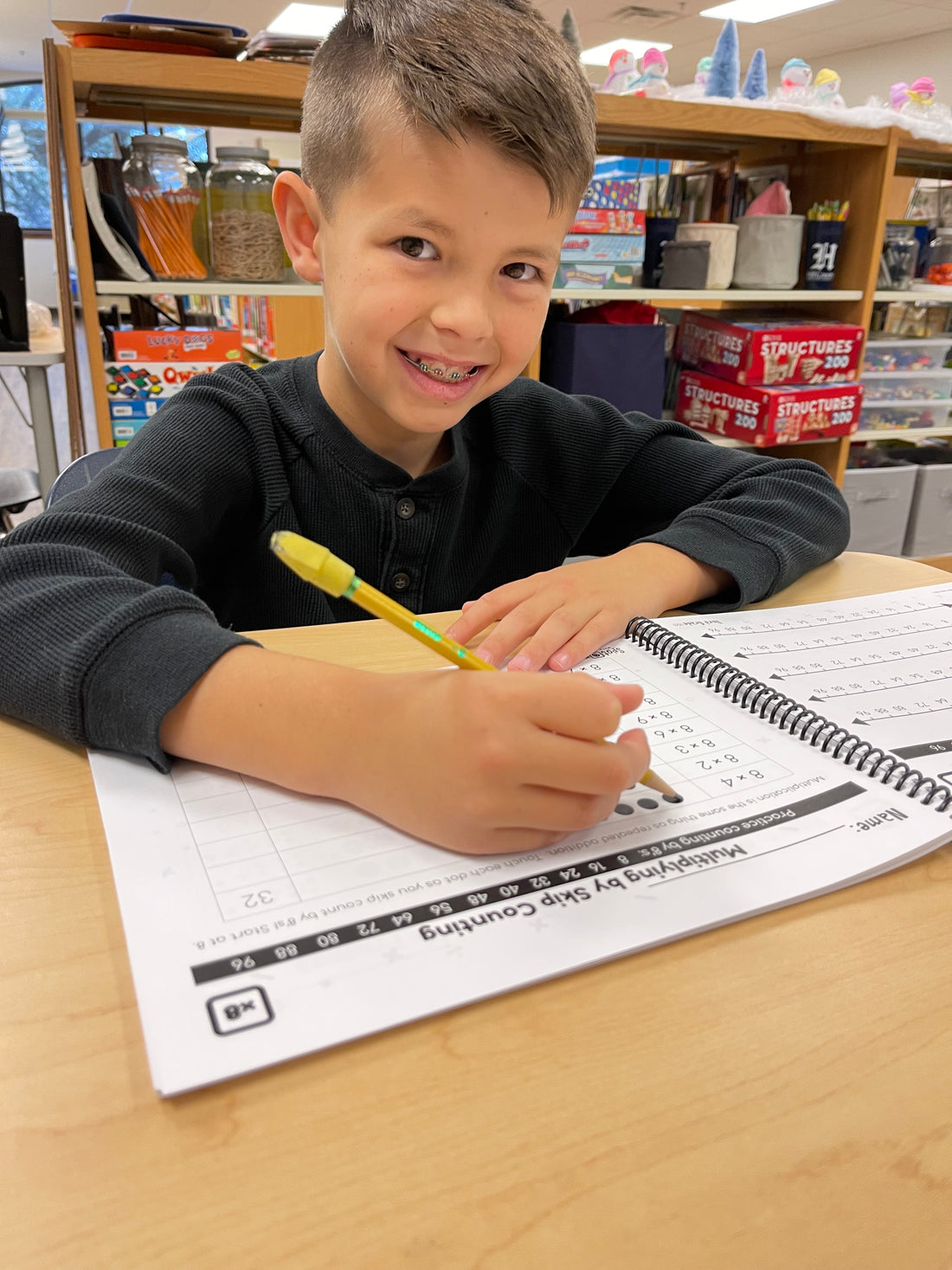 boy practicing math facts multiplication with dots, visual practice